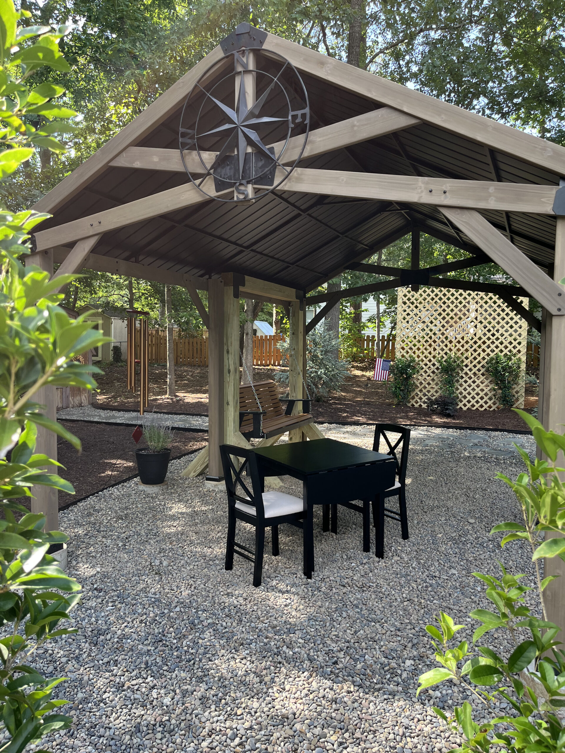 Landscape design by Edison Landscaping. Gazebo with table and chairs